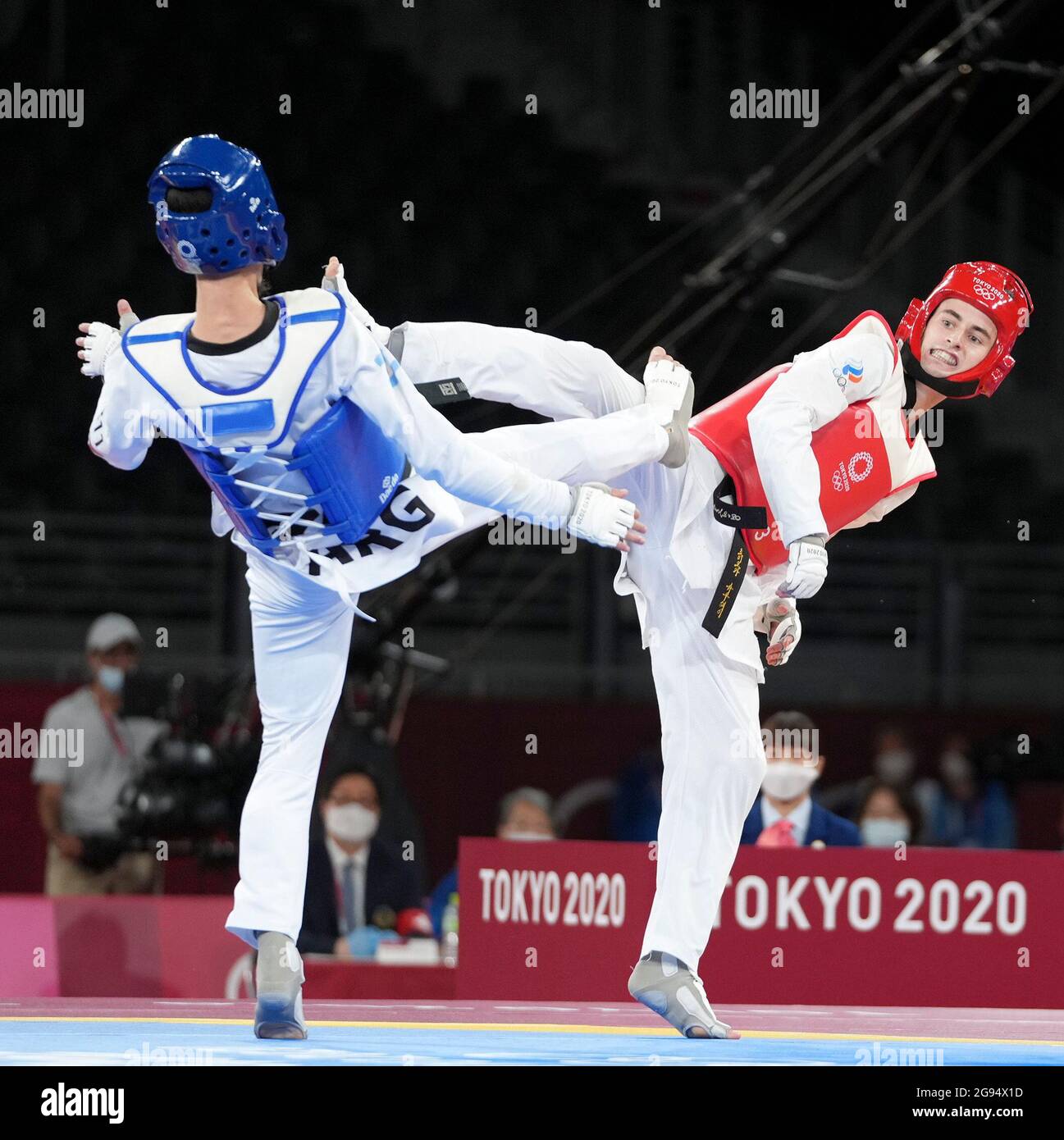 Tokyo, Japan. 24th July, 2021. Mikhail Artamonov (R) of the Russian Olympic Committee (ROC) competes against Lucas Lautaro Guzman of Argentina during the men's 58kg taekwondo bronze medal match at the Tokyo 2020 Olympic Games in Tokyo, Japan, July 24, 2021. Credit: Wang Yuguo/Xinhua/Alamy Live News Stock Photo