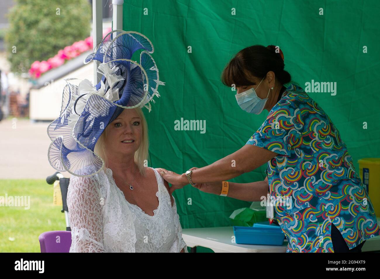 Ascot, Berkshire, UK. 24th July, 2021. Jacqueline Hoole wore a beautiful hat today at Ascot Racecourse and took the opportunity to have her Covid-19 jabs today. Credit: Maureen McLean/Alamy Live News Stock Photo