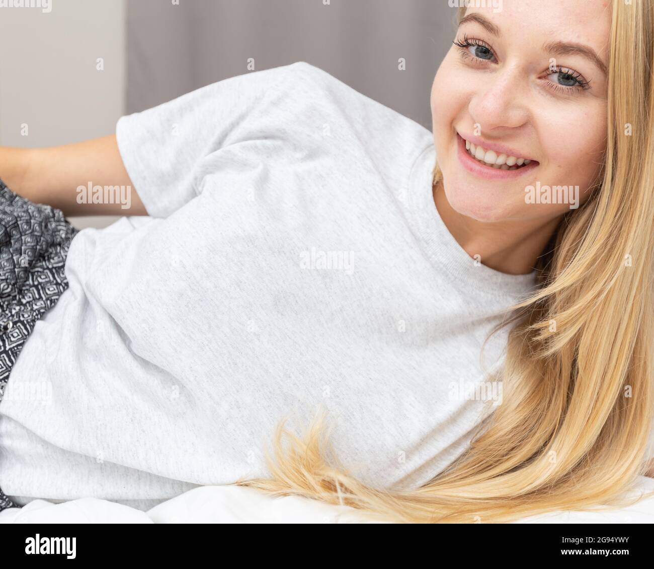 Download Woman Wearing White Tshirt And Lying On Bed Tshirt Mockup Copy Space On Empty Area On Her T Shirt For Design Or Inscription Fashion Lifestyle Mock Up Of White Tshirt T Shirt Template Stock