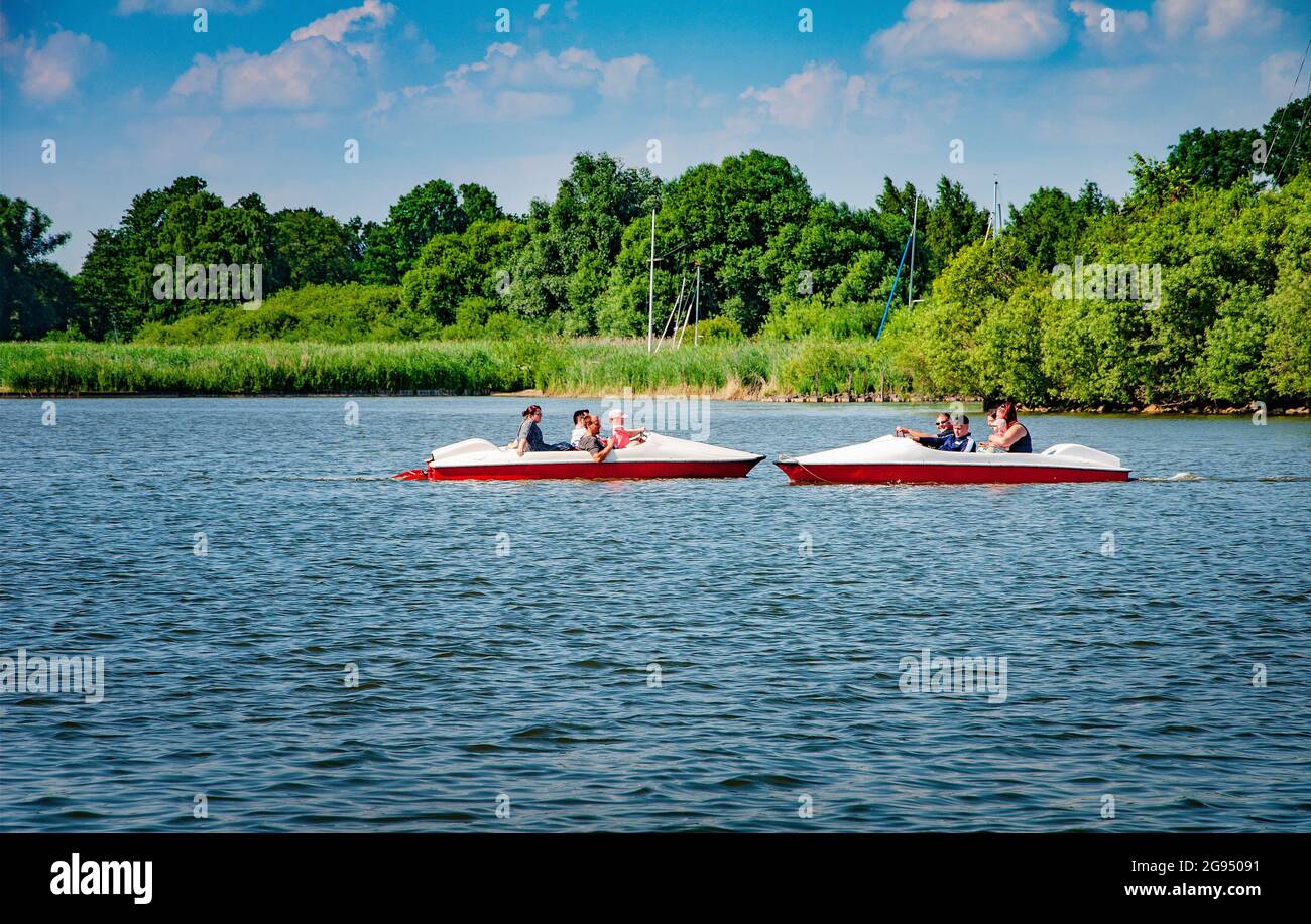 BOHMTE, GERMANY. JUNE 27, 2021 Dammer Natural Park. People ride a pleasure boat. Lake view. Forest on the background Stock Photo