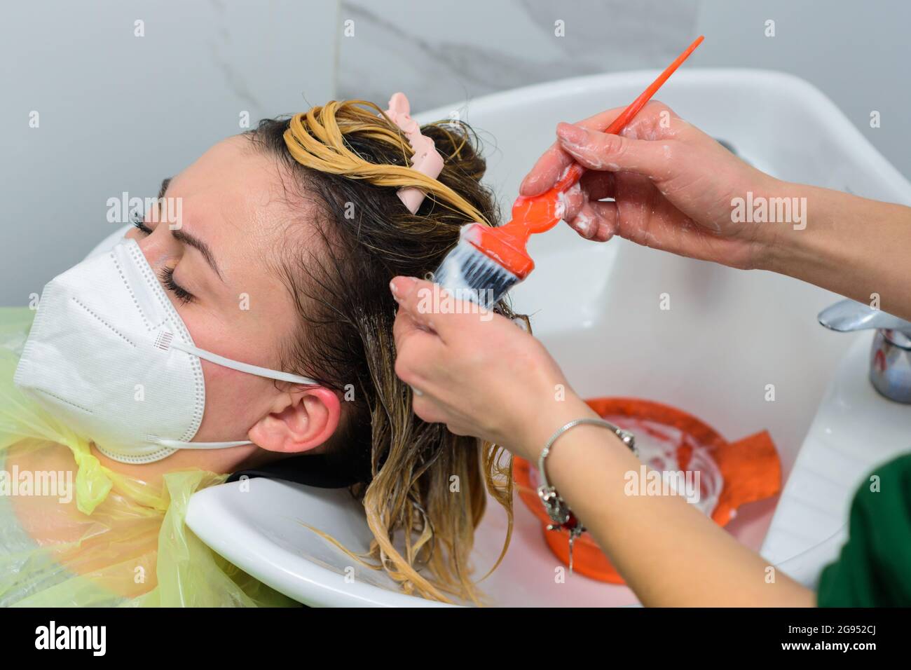 Applying conditioner after shampoo, hair care in the salon, balayage