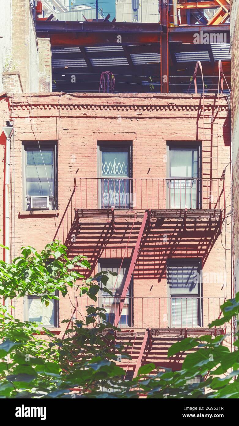 Old brick building with fire escape in New York City, color toning ...