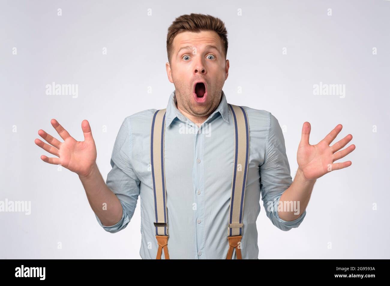 Man with shocked, amazed expression with opened mouth looking at camera Stock Photo