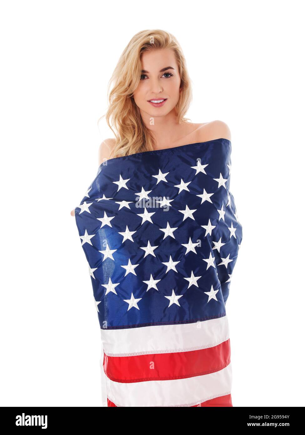 Beautiful blond woman wrapped only in an American flag. Stock Photo