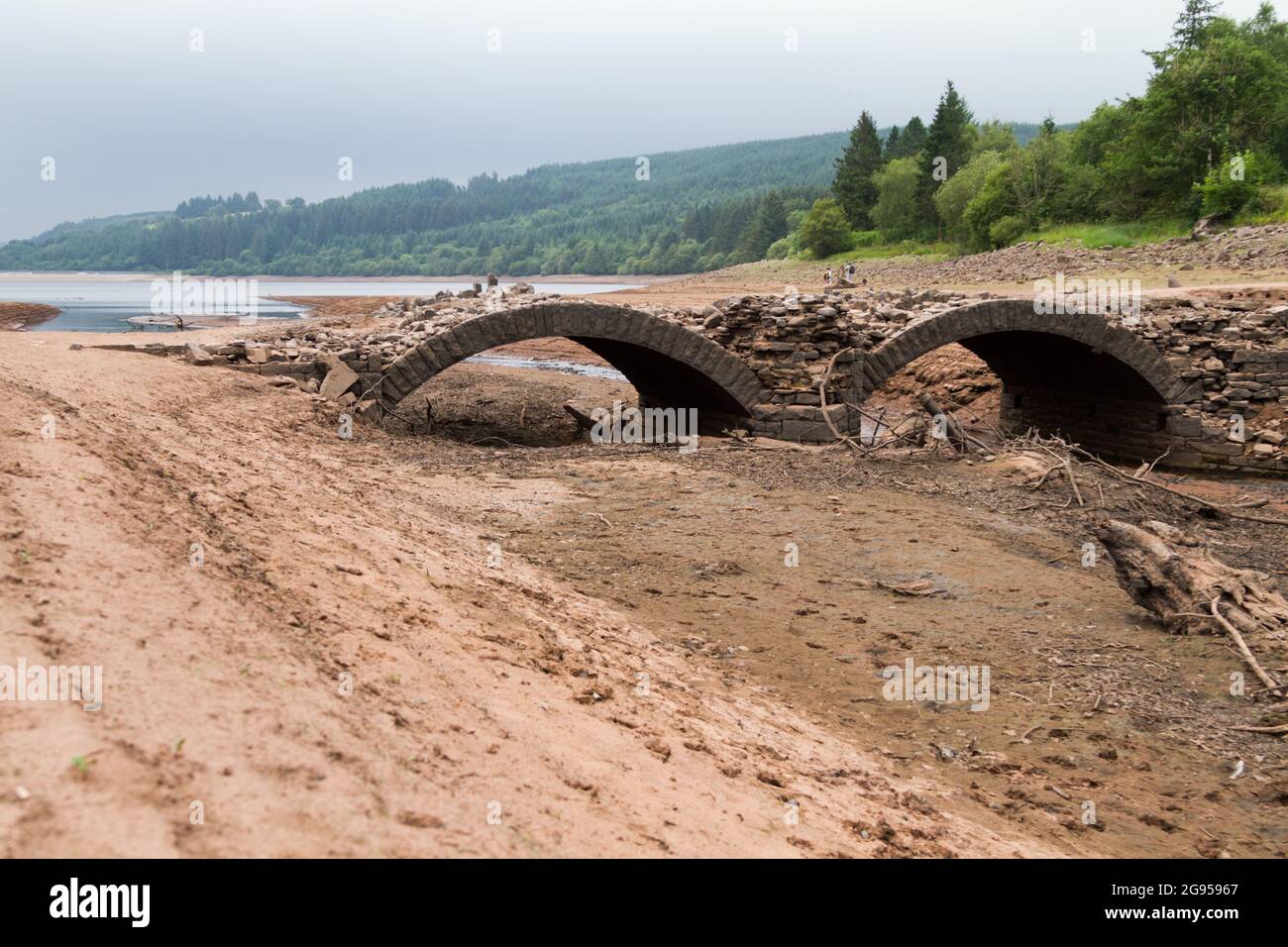 UK weather: Llwyn Onn reservoir, Merthyr Tydfil, South Wales. 24 July 2021. Water levels continue to deplete after the heatwave. Credit: Andrew Bartlett/Alamy Live News. Stock Photo