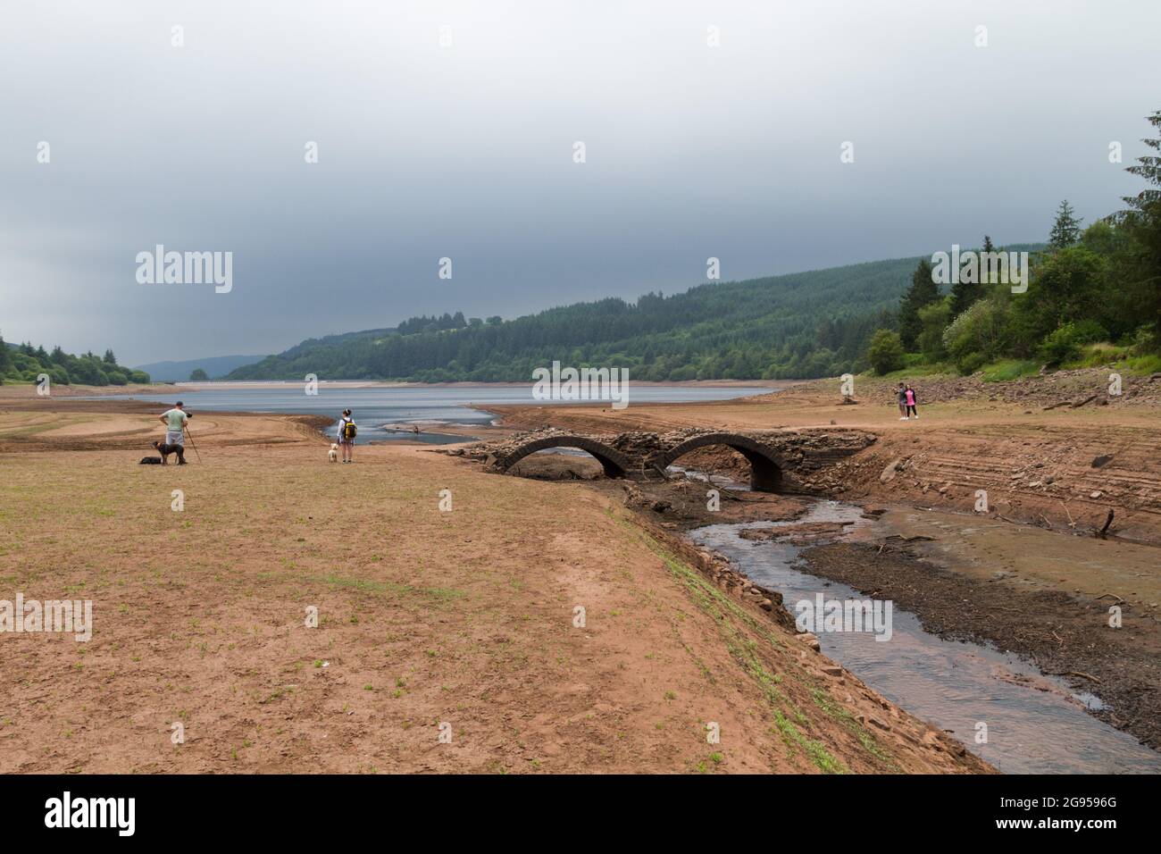 UK weather: Llwyn Onn reservoir, Merthyr Tydfil, South Wales. 24 July 2021. Water levels continue to deplete after the heatwave. Credit: Andrew Bartlett/Alamy Live News. Stock Photo