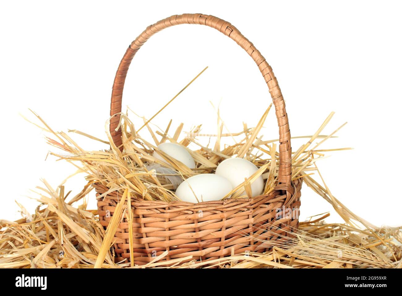 white eggs in a wicker bascet on straw on white background Stock Photo ...