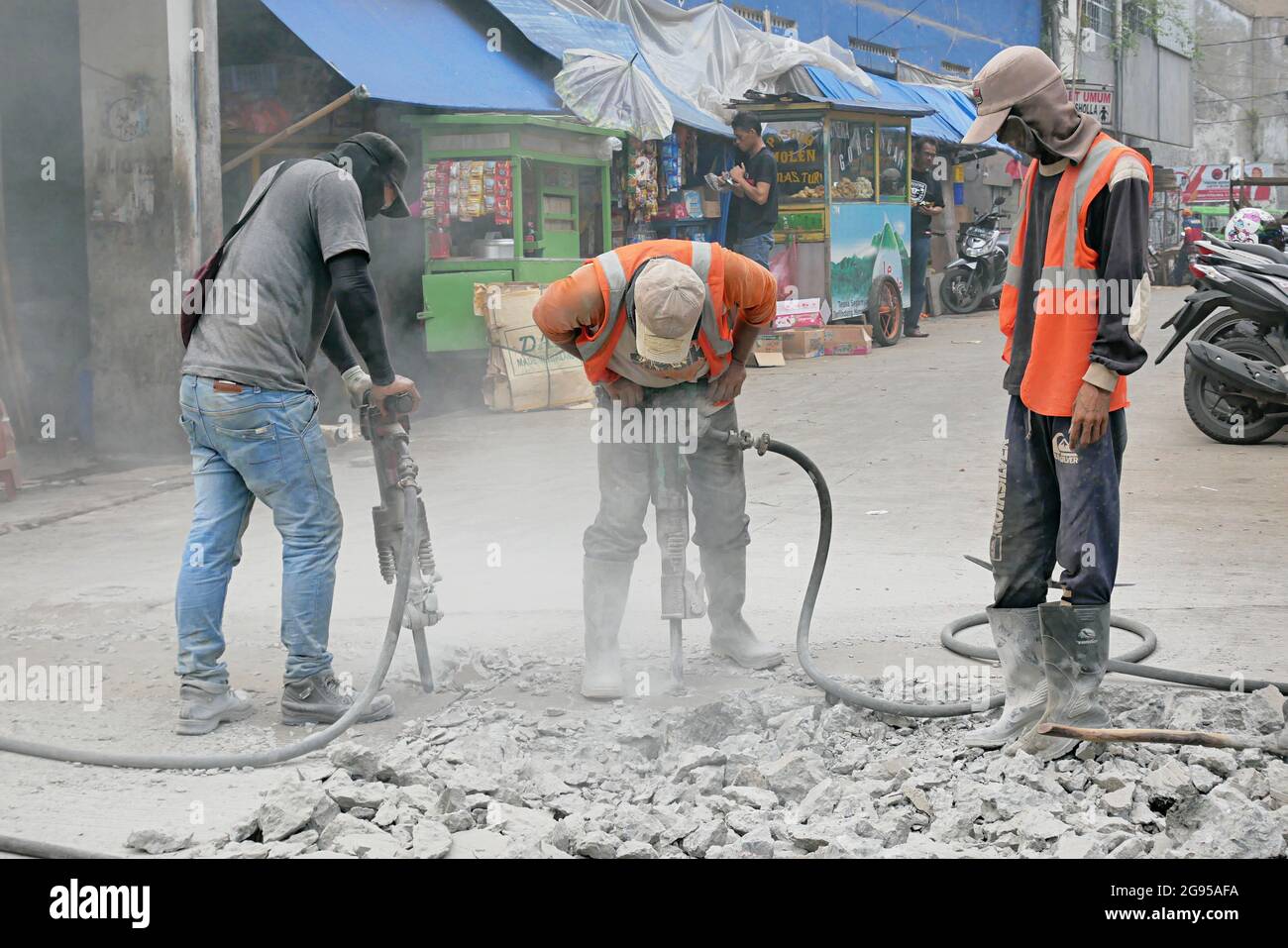 Construction workers are using jack hammer tools to destroy the street  concrete Stock Photo - Alamy
