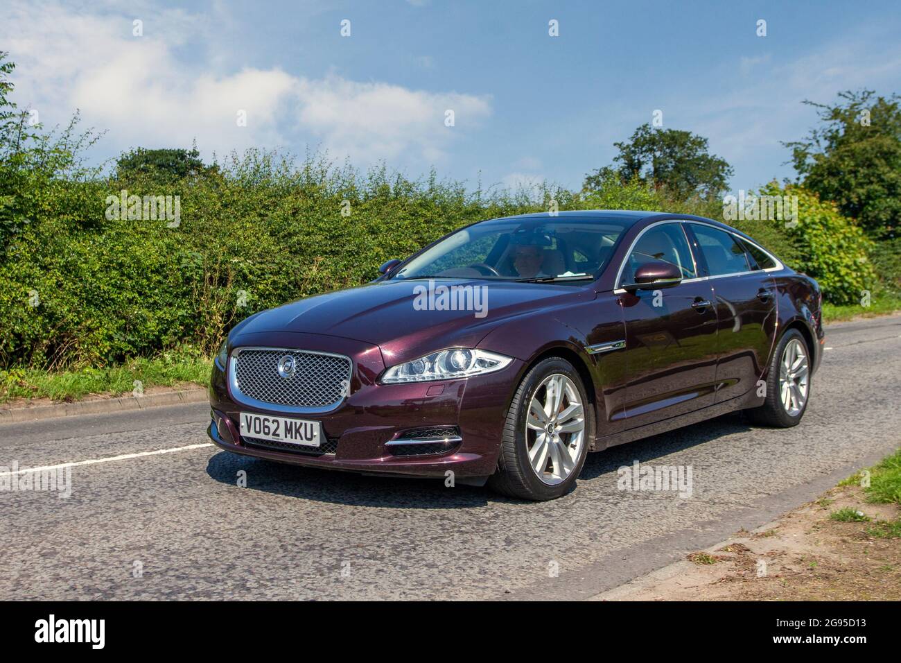 2012 red Jaguar XJ Premium Luxury V6 D A en-route to Capesthorne Hall classic July car show, Cheshire, UK Stock Photo