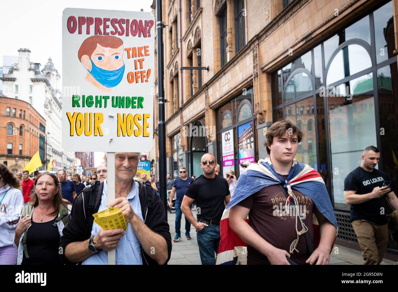 Manchester, UK. 24th July, 2021. A man with a placard joins the protesters against the lockdowns. People march through Piccadilly for a global Worldwide Rally For Freedom demonstration. Credit: Andy Barton/Alamy Live News Stock Photo