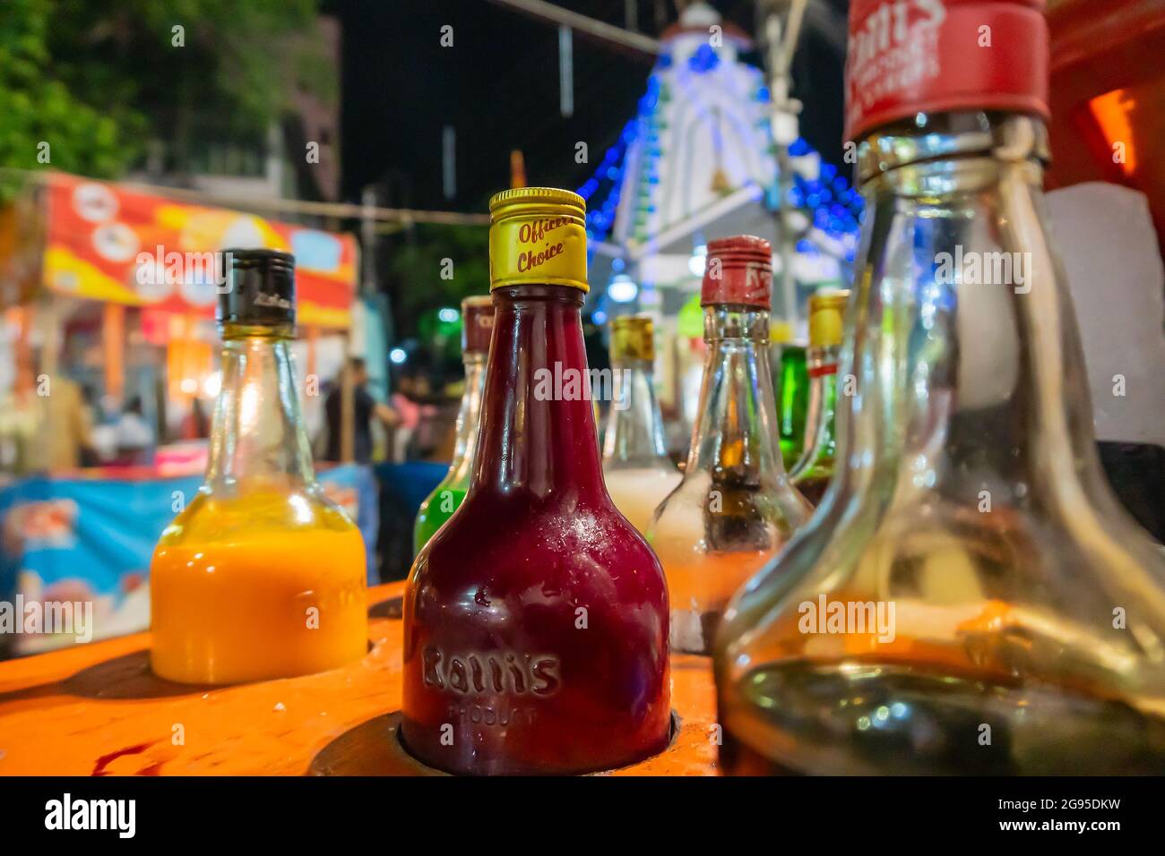 Howrah, West Bengal, India- April 14th 2019 : Colourful juices and syrups for making ice gold or Barf ka gola or chuski or gola ganda, a summer drink. Stock Photo