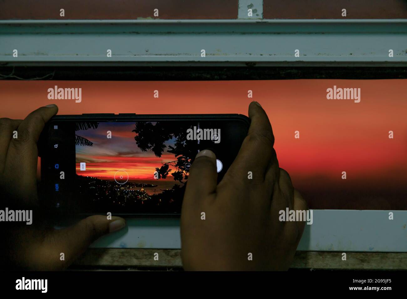 sunset on the screen of a smart phone Stock Photo