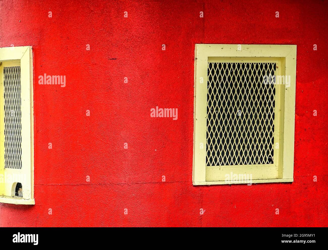 Red wall and yellow window in an old amusement park Stock Photo - Alamy