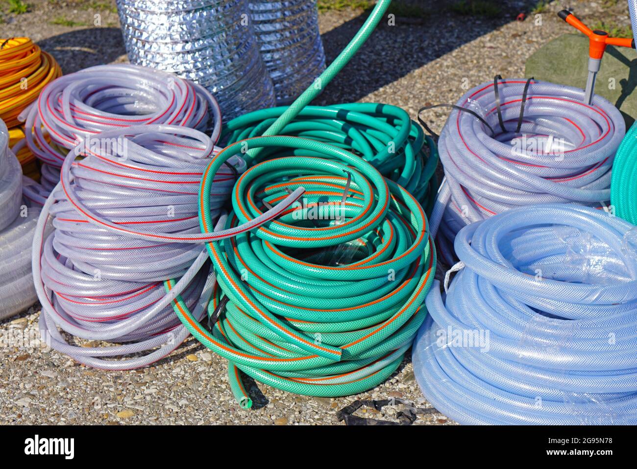 Many plastic and rubber garden water hose tube Stock Photo