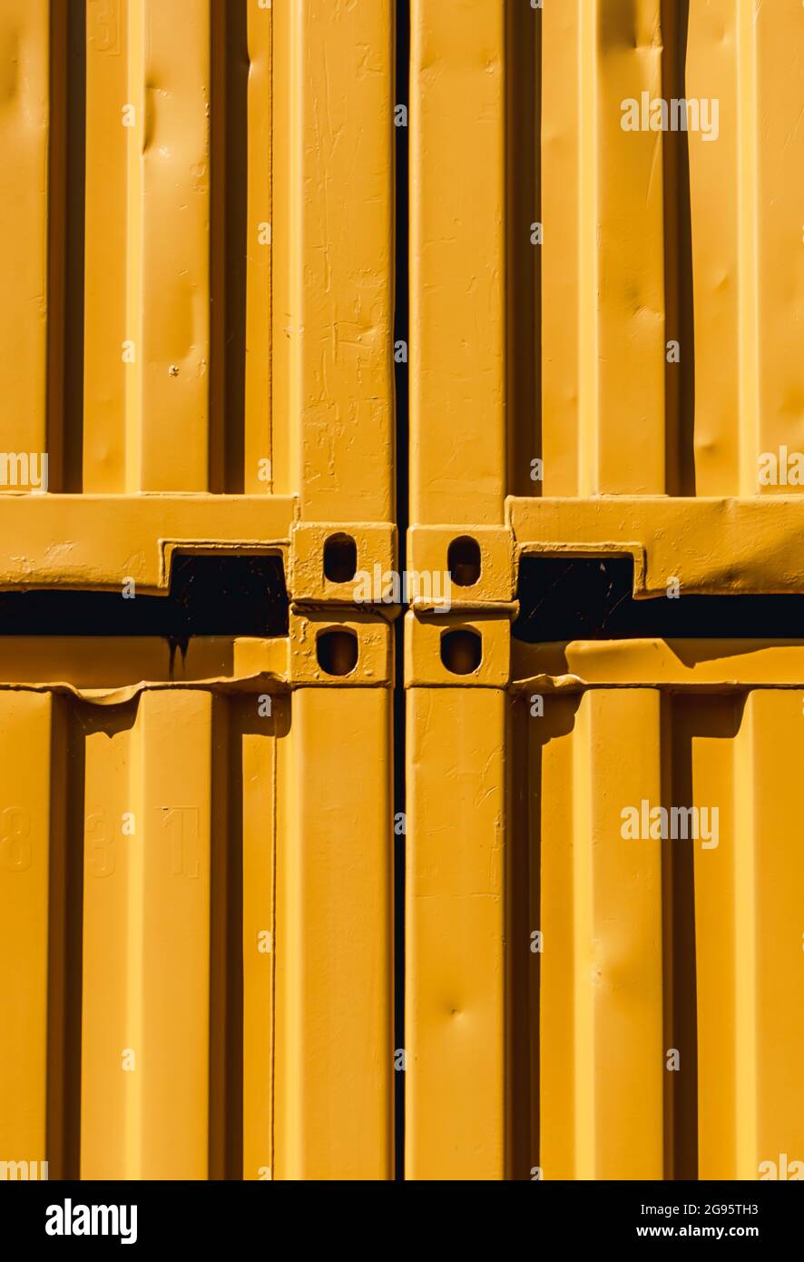 Vertical Abstract image of stacked yellow shipping containers in the sunlight Stock Photo