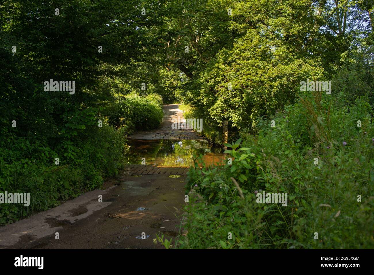 The ford road crossing at foxes lane near Romsey hampshire. Image is  on as summers day in winter the crossing can reach over 6ft & can be impassable. Stock Photo