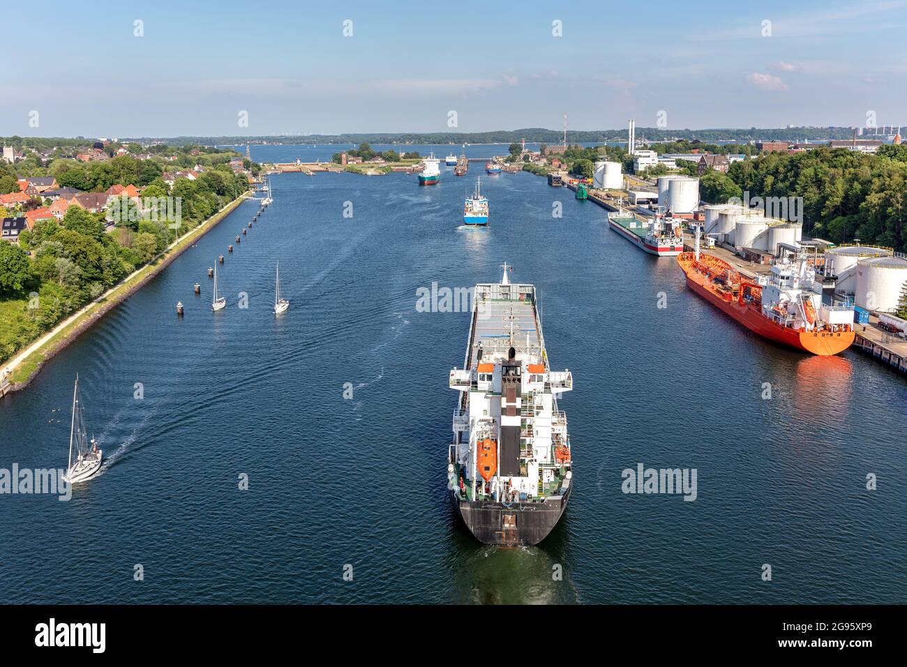 ships in the Kiel canal with Holtenau Locks in the background Stock Photo