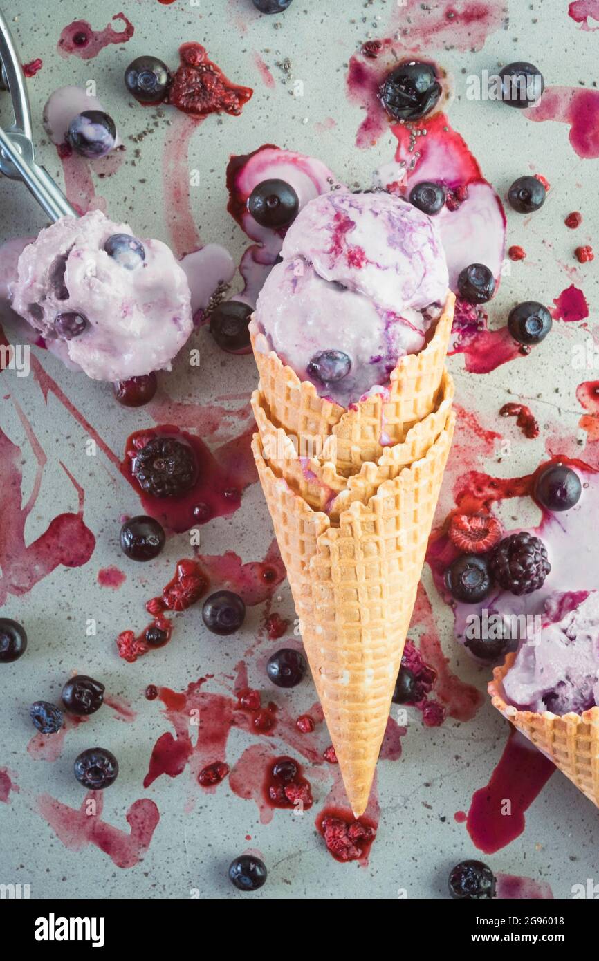 Melting berry ice cream lying down in a waffle cone Stock Photo