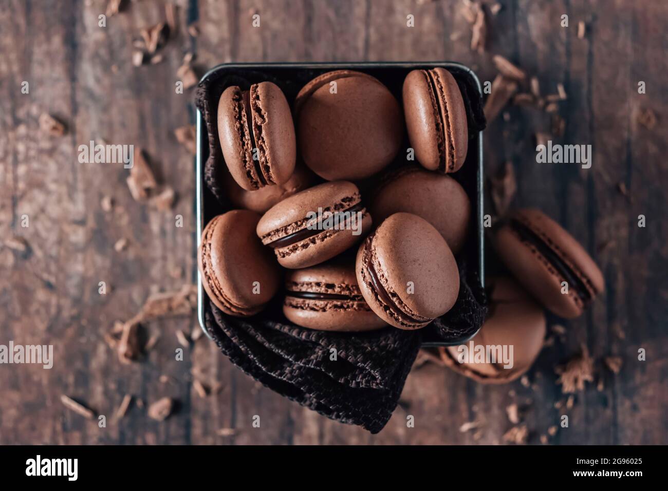 Chocolate macarons on wooden table Stock Photo