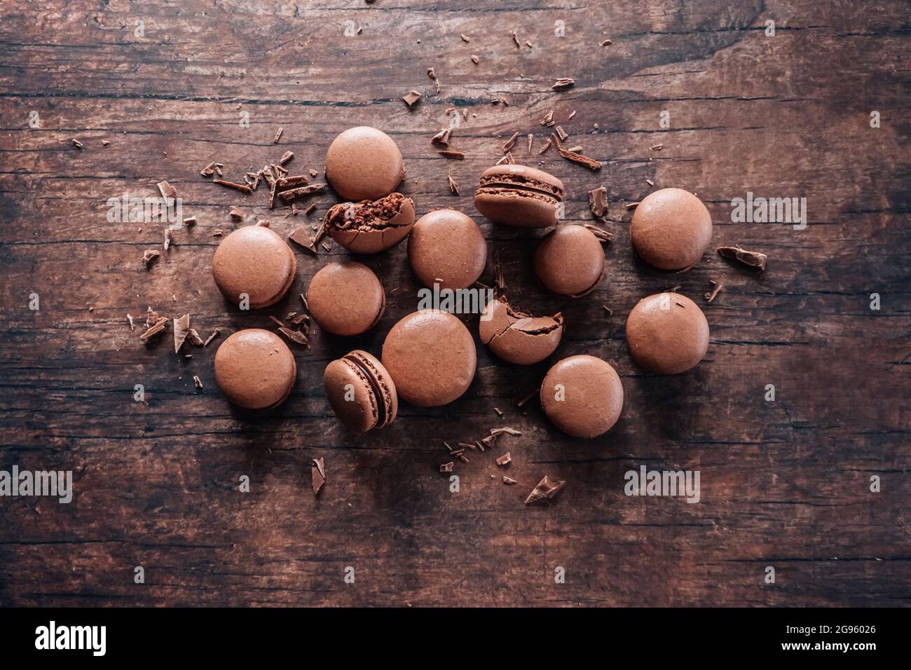 Chocolate macarons lying on wooden table Stock Photo