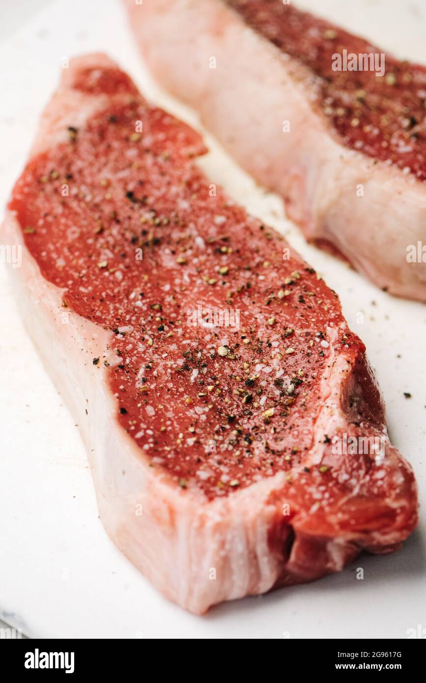 Raw cuts of seasoned flat iron steak Stock Photo Alamy