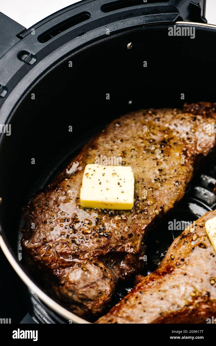 Melting butter over Air Fryer steaks Stock Photo Alamy