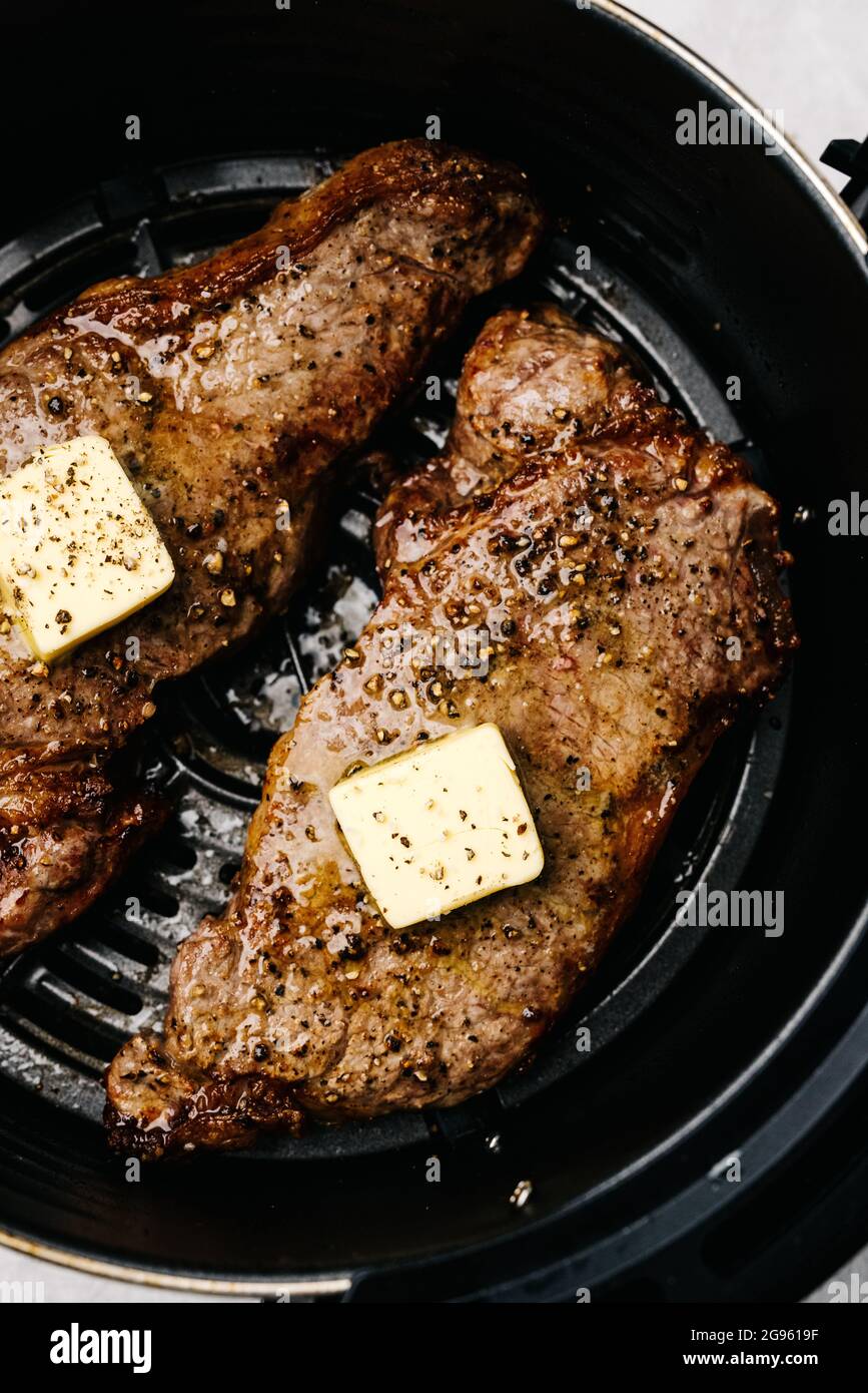 Closeup of air fryer steaks with butter Stock Photo Alamy
