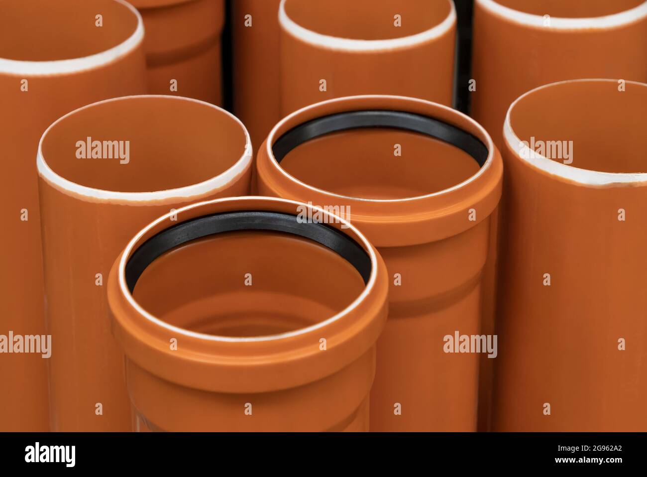 Stack of PVC U canalization pipes plumbing tube on a hardware store
