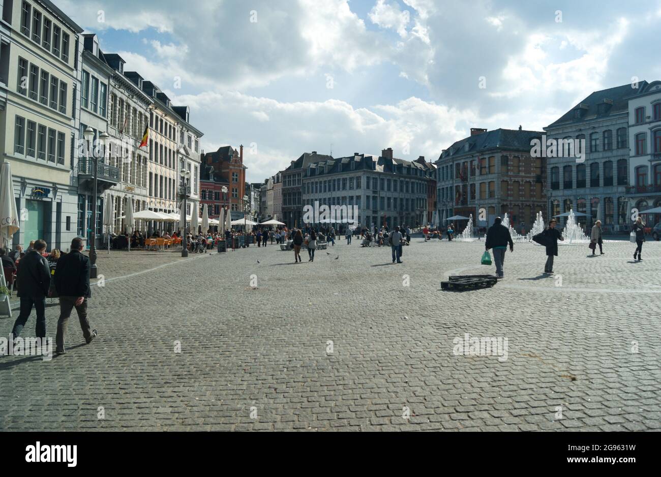 Mons / Belgium / May 7 2012 :  The town square in the heart of the old city.  Elegant  buildings surround the open, cobbled, space. People relax at pa Stock Photo