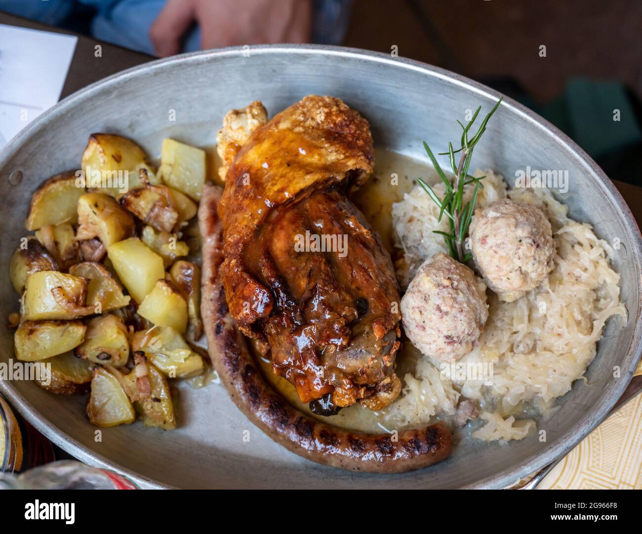 An appetizing pan with some Trentino specialties baked pork shank