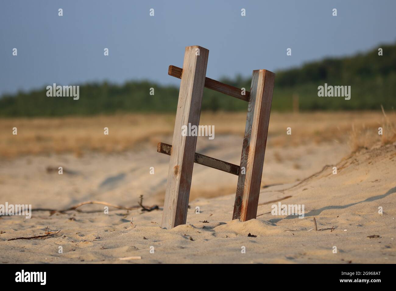 Sandy arid dried area, abandoned wooden ladder, Bledowska Desert in Poland, desrtification of the Eart, climate changing. Stock Photo