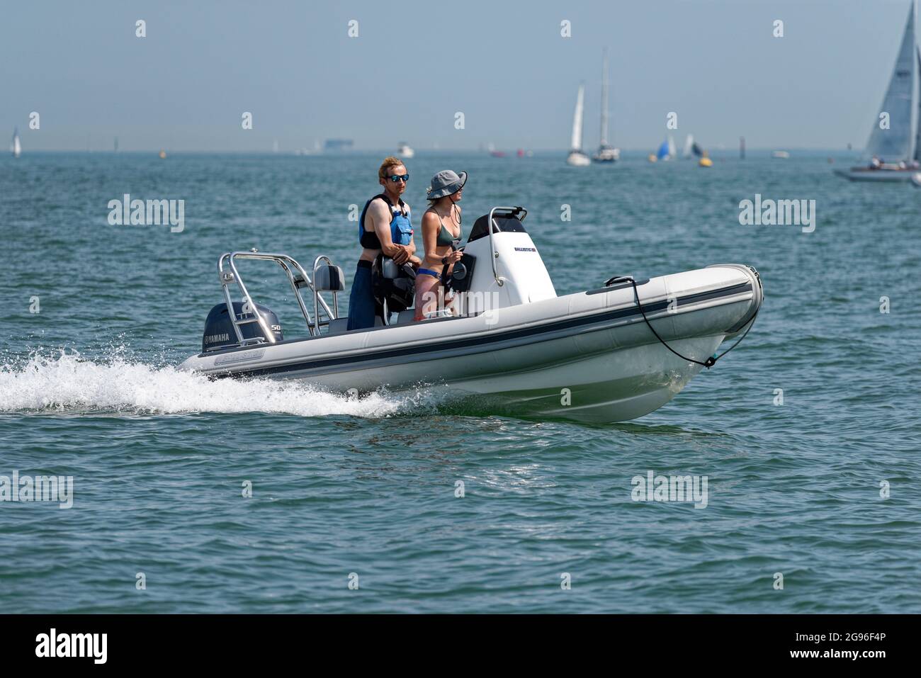 A couple having fun on their British Ballistic Rib out in The Solent at the Cowes Classic Yacht Regatta Stock Photo