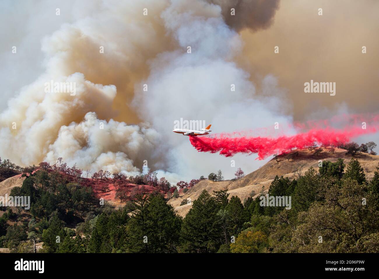 A DC-10 air tanker operated by Tanker 10 drops retardant on the Kincade fire in Sonoma County, California on October 24, 2019. Stock Photo