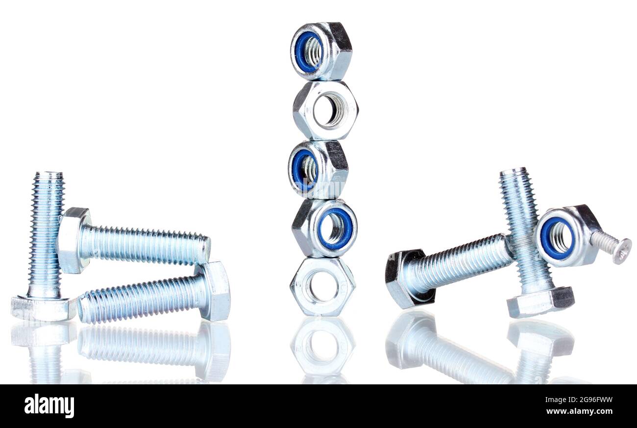 Stacks of balanced screws and screwnuts isolated on white Stock Photo