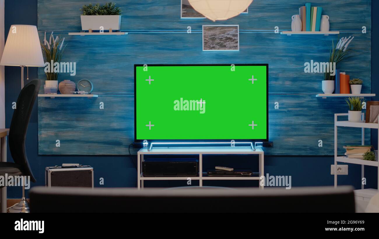 Empty room with green screen on television in living room at modern