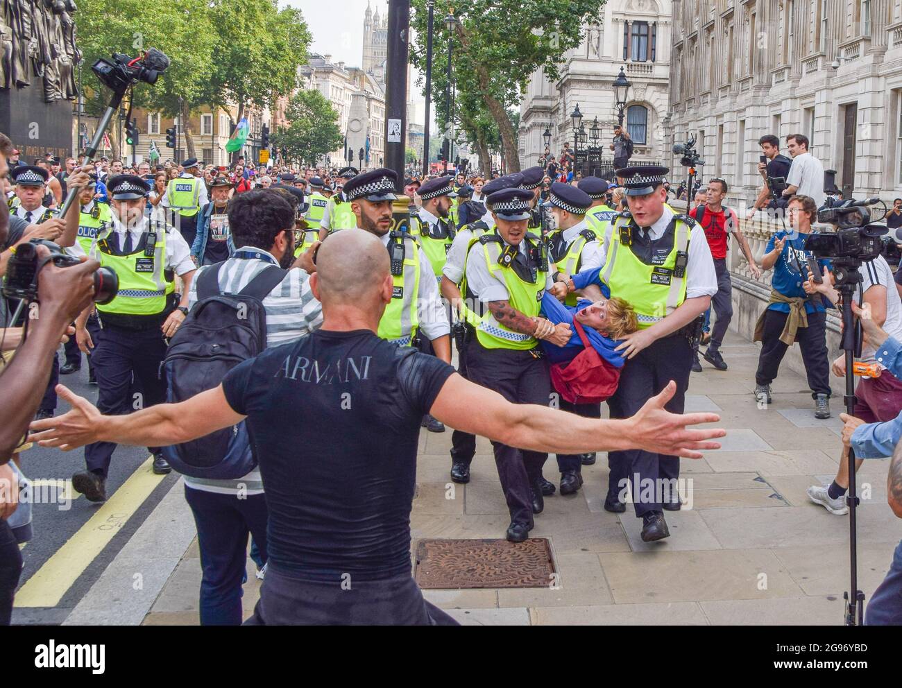 London, United Kingdom. 24th July 2021. Police arrest a protester in Whitehall. Thousands of protesters gathered in Westminster to protest against COVID-19 vaccinations, vaccine passports, and coronavirus restrictions, with many demonstrators calling the pandemic a 'hoax'. (Credit: Vuk Valcic / Alamy Live News) Stock Photo