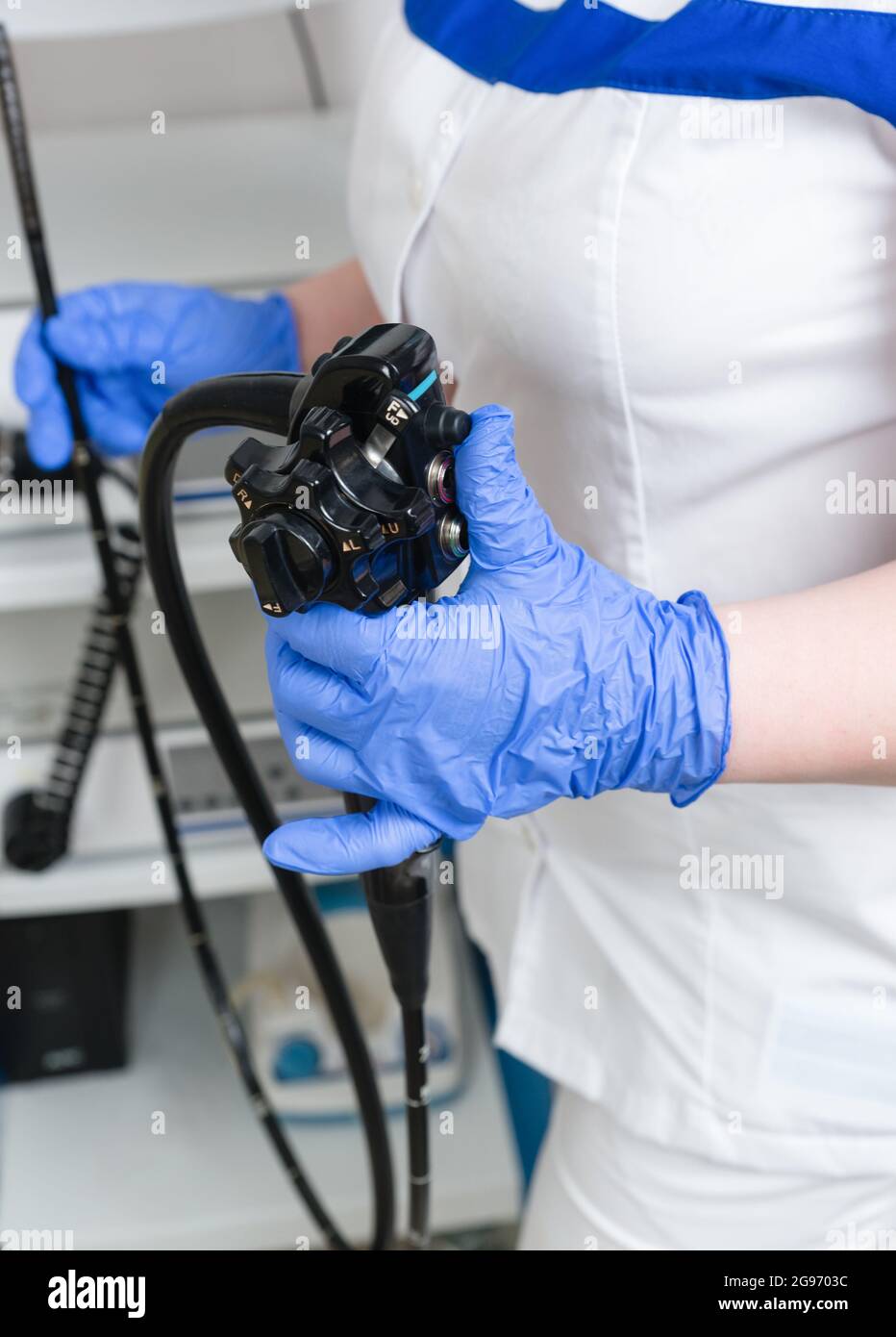 Medical equipment for video esophagogastroduodenoscopy in the hands of blue gloves. Conducting the examination procedure Stock Photo