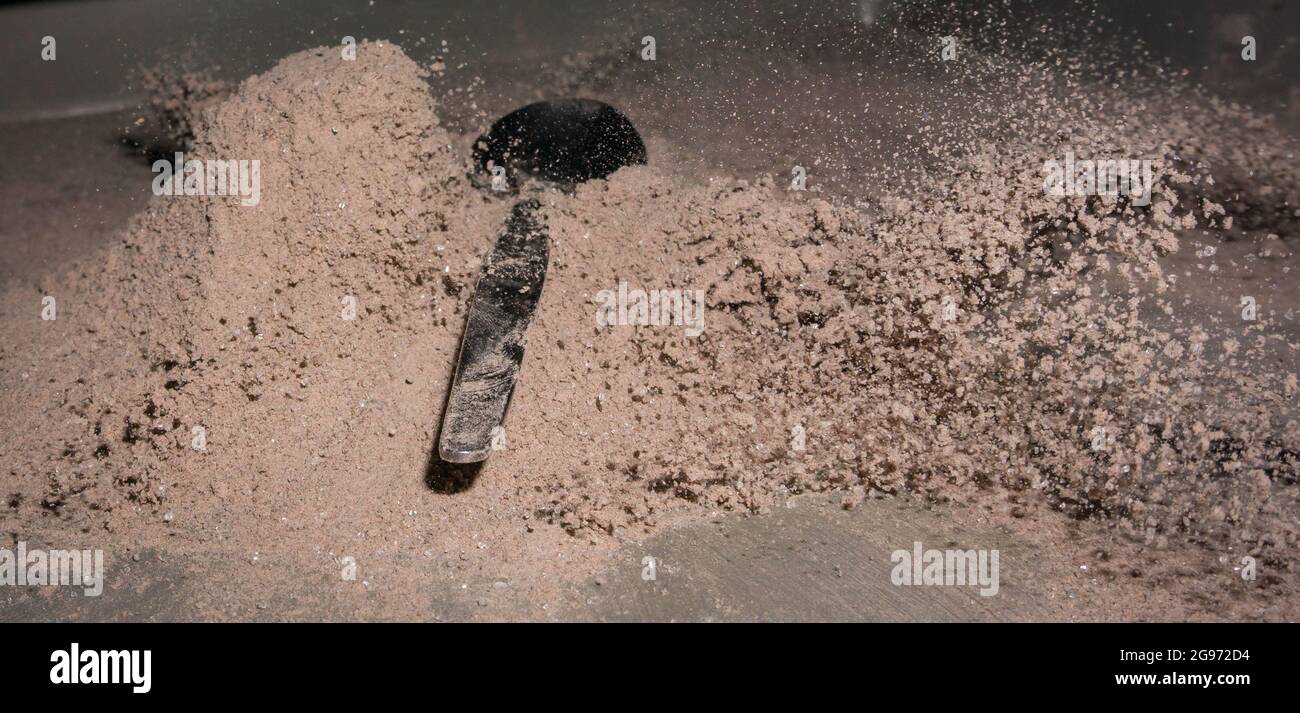 Cocoa splash with a spoon, studio shot Stock Photo