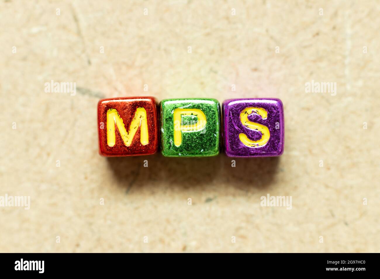 Metallic color alphabet letter block in word MPS (Abbreviation of Master Production Schedule or Mucopolysaccharidosis) on wood background Stock Photo