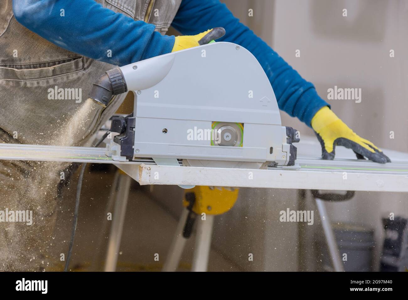 Close Up process cutting of hand circular saw at wood door cuts Stock