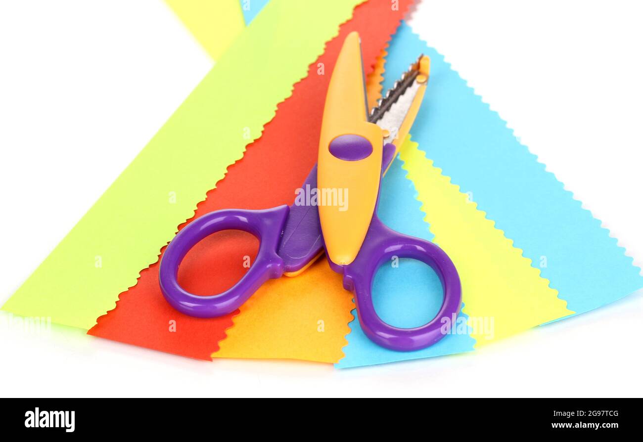 Colorful zigzag scissors with color paper isolated on white Stock Photo