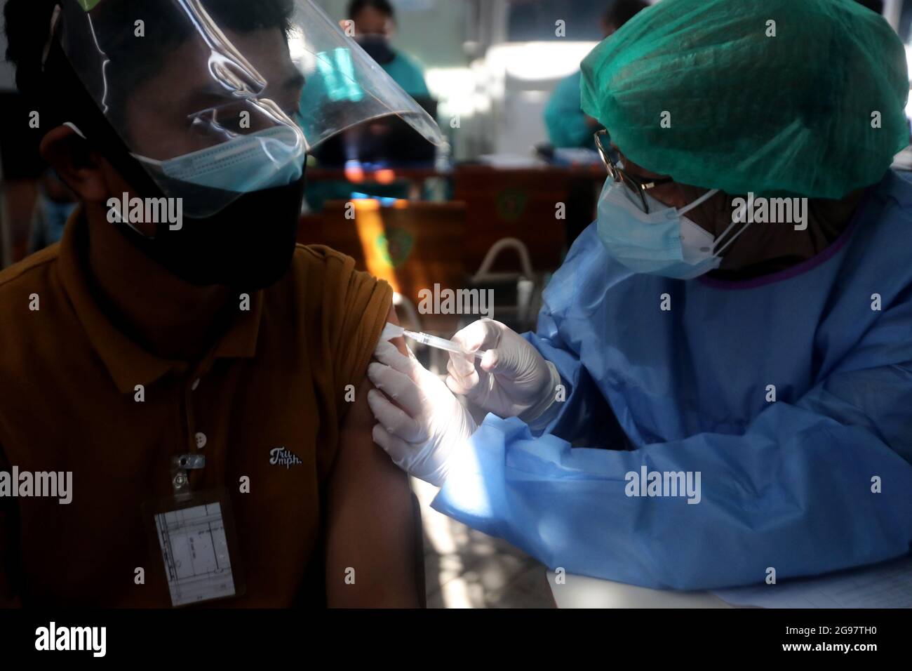 Sidoarjo, Indonesia. 24th July, 2021. A Laborer receives the Sinovac Covid-19 vaccine during a vaccination for Laborer in Sidoarjo, East Java, Indonesia, on July 24, 2021. (Photo by Boy Slamet/INA Photo Agency/Sipa USA) Credit: Sipa USA/Alamy Live News Stock Photo