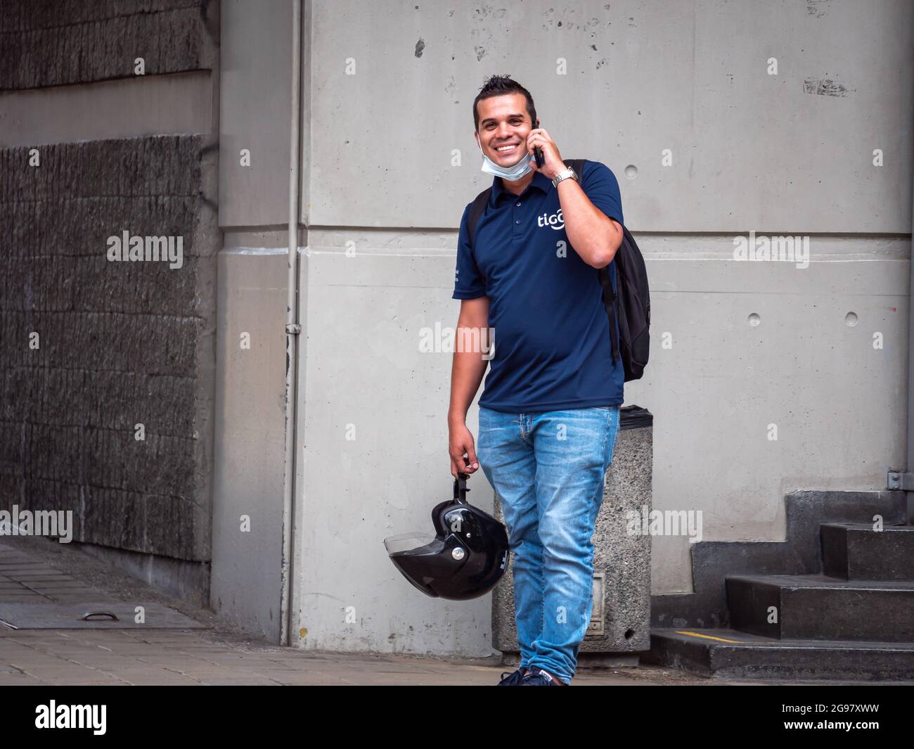 Medellin, Colombia - July 21 2021: Latin Men in Shirt and Jeans and Mask on  his Chin Talks on the Phone Standing on the Sidewalk Happily Stock Photo -  Alamy