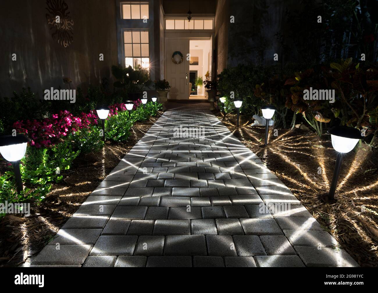 Illuminated Walkway to Front Door at Nighttime Stock Photo - Alamy