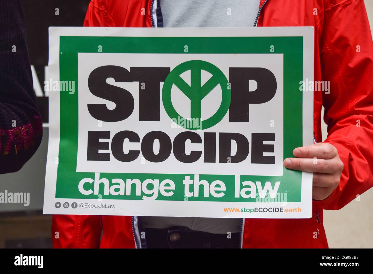 London, UK. 24th July, 2021. A protester holds a placard which says 'Stop Ecocide, Change The Law', during the demonstration.Forest Rebellion demonstrators, part of Extinction Rebellion, gathered outside the Timber Trade Federation in protest against the clear-cutting of the last natural forests is Sweden, and in solidarity with the indigenous Sami people. (Photo by Vuk Valcic/SOPA Images/Sipa USA) Credit: Sipa USA/Alamy Live News Stock Photo