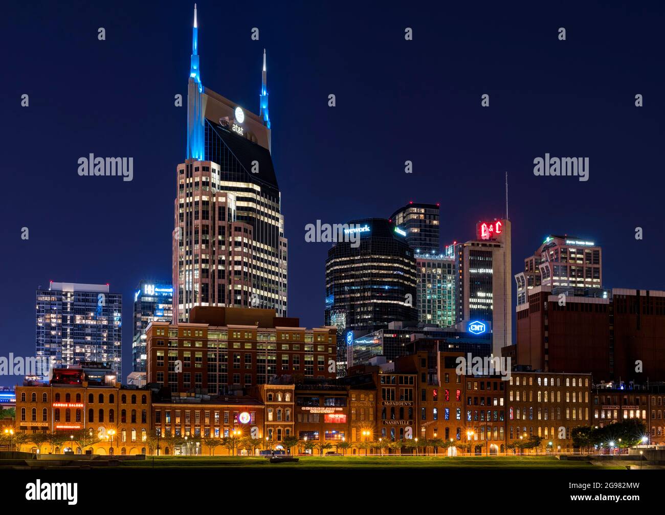 AT&T Building (Batman Building) in Downtown Nashville illuminated at night. View from Cumberland Park, Nashville, Tennessee, USA. Stock Photo