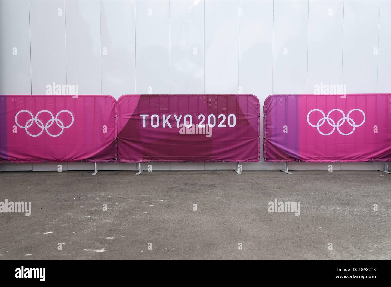 Tokio Japan 24th July 2021 Equestrian Sport Dressage Olympics Preliminary Competition Individual Grand Prix At The Baji Koen Equestrian Park A Banner With Tokyo 2020 And The Symbol Of The Olympic Rings Is