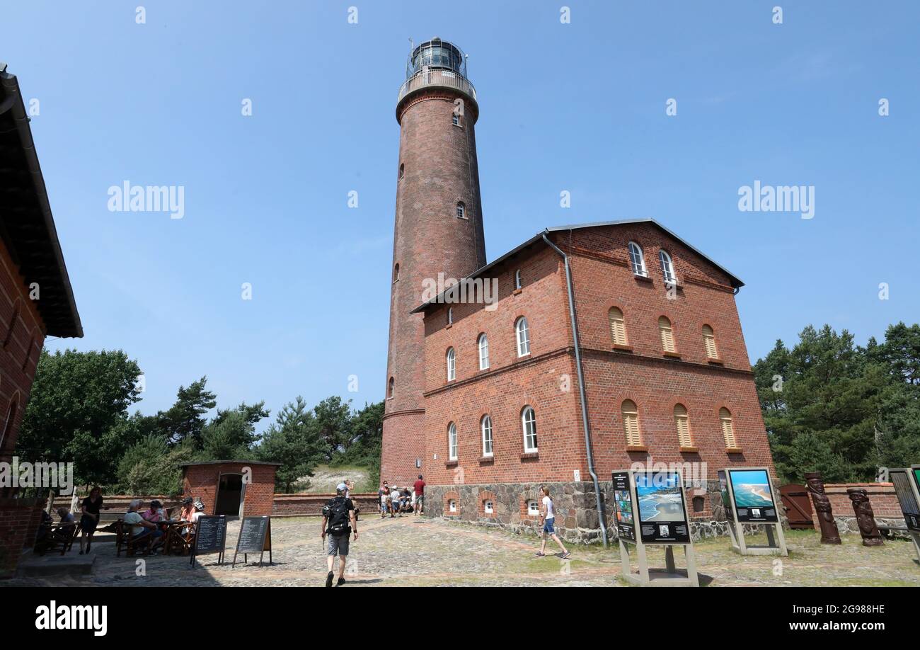 Prerow, Germany. 13th July, 2021. At Darßer Ort in the core zone of the National Park Vorpommersche Boddenlandschaft visitors are walking in front of the Natureum at the lighthouse. The Natural History Museum was opened on 01.06.1991 shortly after the foundation of the National Park as a branch of the German Oceanographic Museum. The exhibitions inform about the flora and fauna on the Darß and the Baltic Sea. Credit: Bernd Wüstneck/dpa-Zentralbild/dpa/Alamy Live News Stock Photo