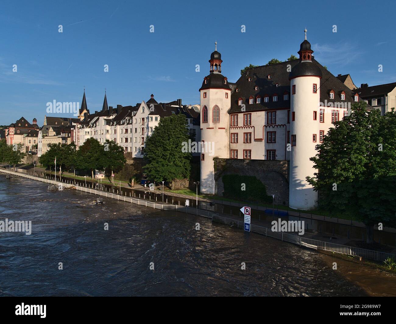 View of Moselle river at high water level with flooded promenade of town Koblenz and fortress castle Alte Burg (old castle, today city archive). Stock Photo