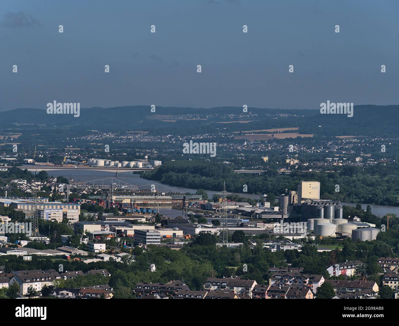 Aerial view of the north of city Koblenz with Rhine river and inland port with tanks and industrial buildings on sunny summer day. Stock Photo